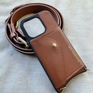 Bandolier leather cross-body iPhone 14 Pro case with leather and ribbon strap.